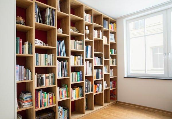 Custom built-in oak bookshelf with adjustable shelves and hidden lighting
